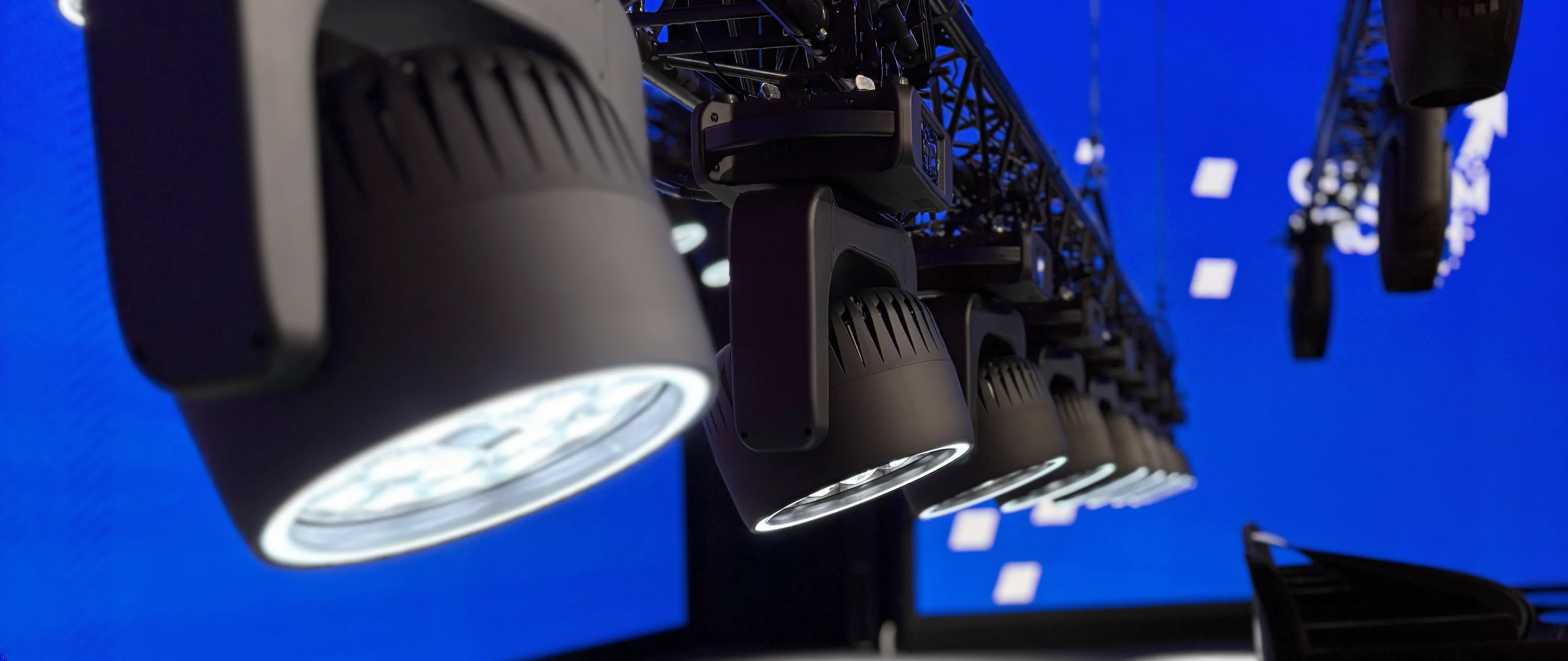 Moving head fixtures on truss with red LED wall